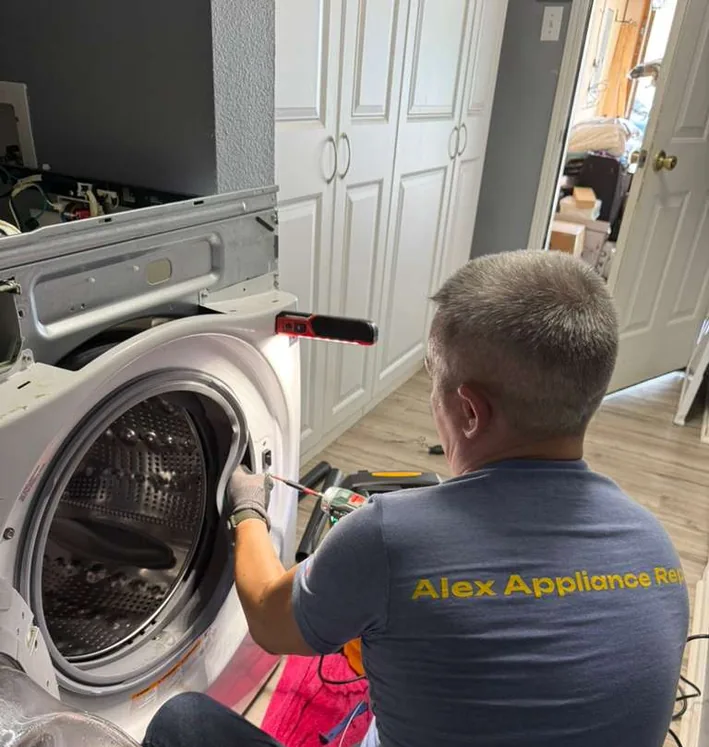 Alex Appliance Repair technician repairing a front-load washing machine in an Indiana home