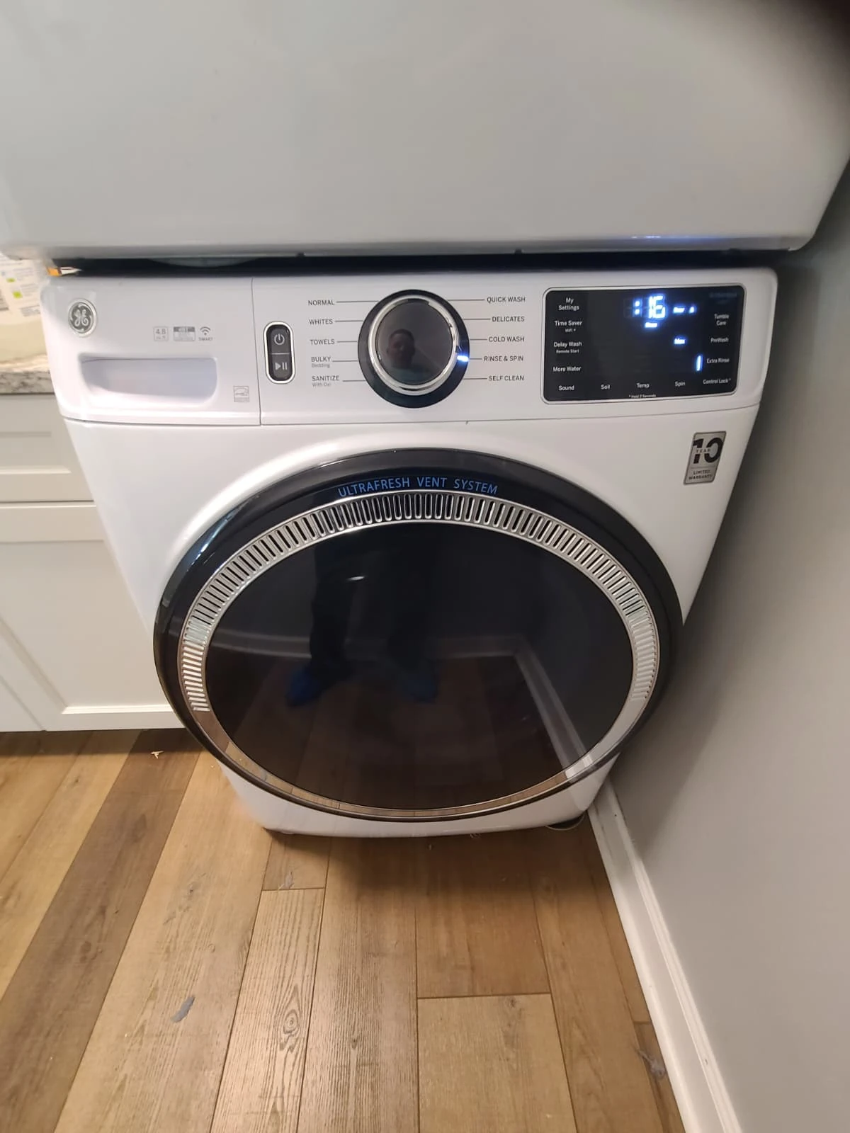 GE GFW550SSN3WW front-load washer beneath a stacked dryer at the Carmel service visit