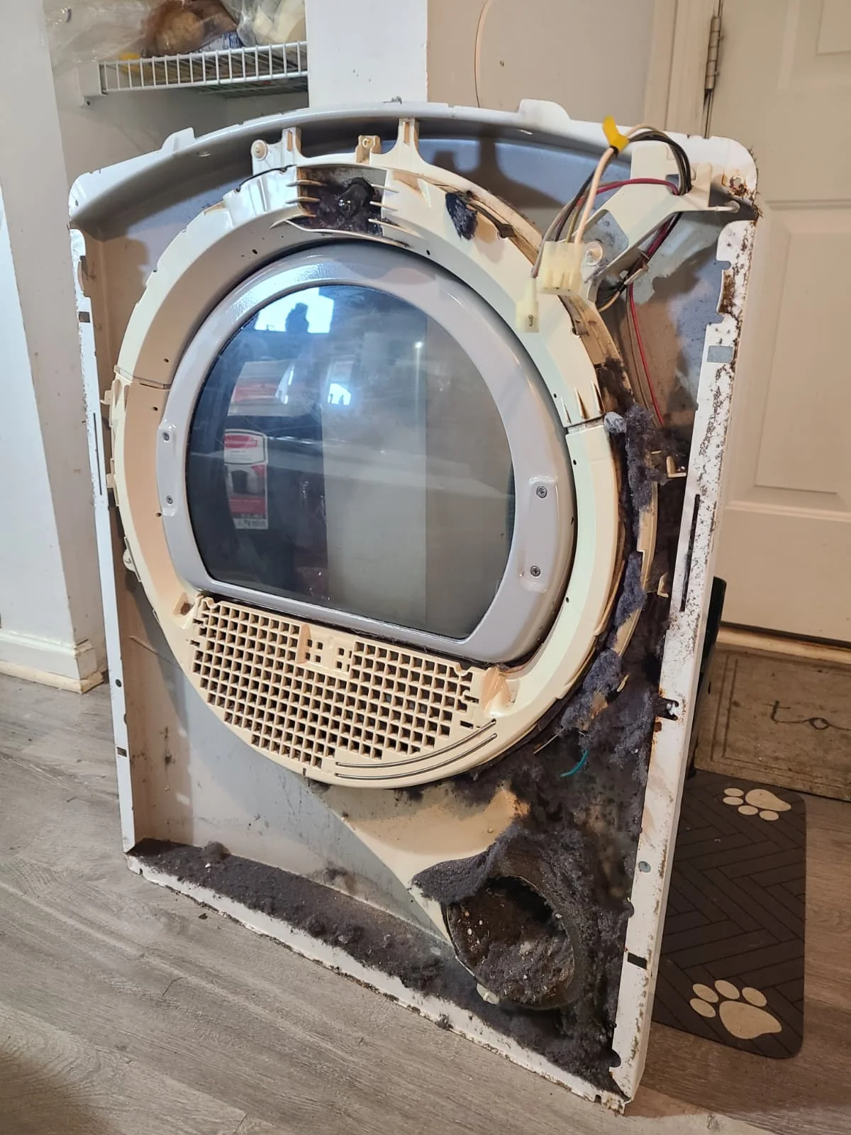 Before: thick lint buildup around the removed front panel and lower air passage