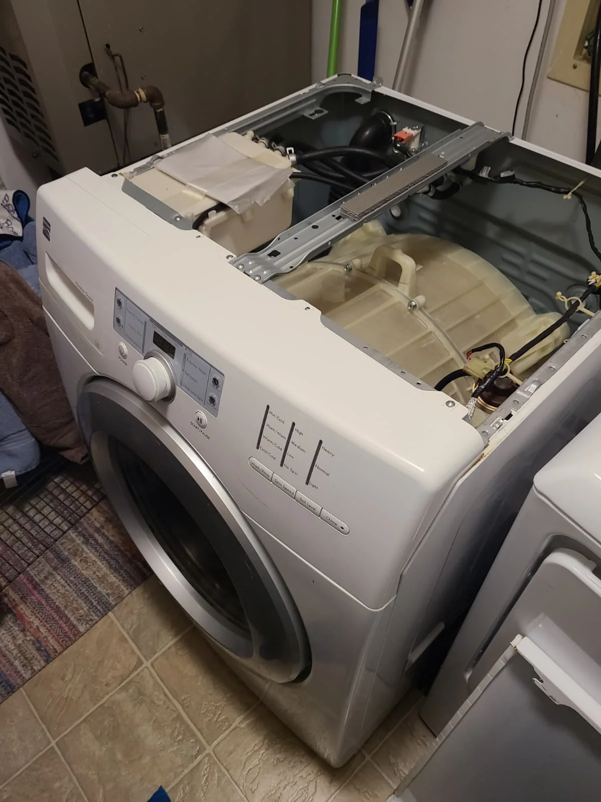 Kenmore front-load washer with its top removed during service in Fishers, Indiana