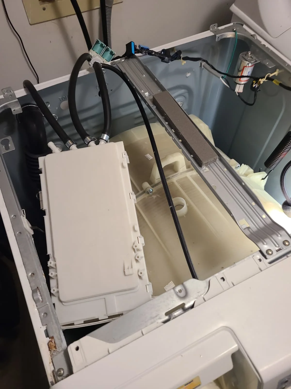 Replacement drawer housing positioned inside the washer during installation