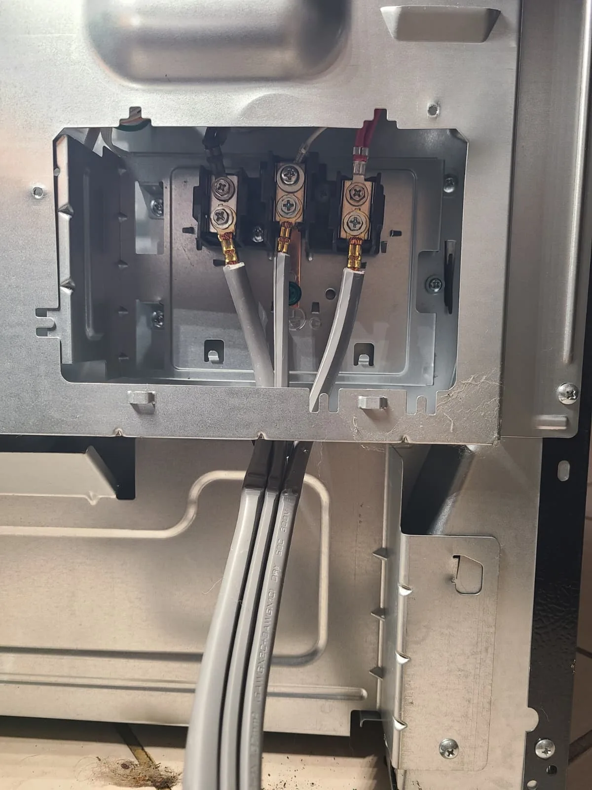 Rear connection area with replacement terminal block and range power cord