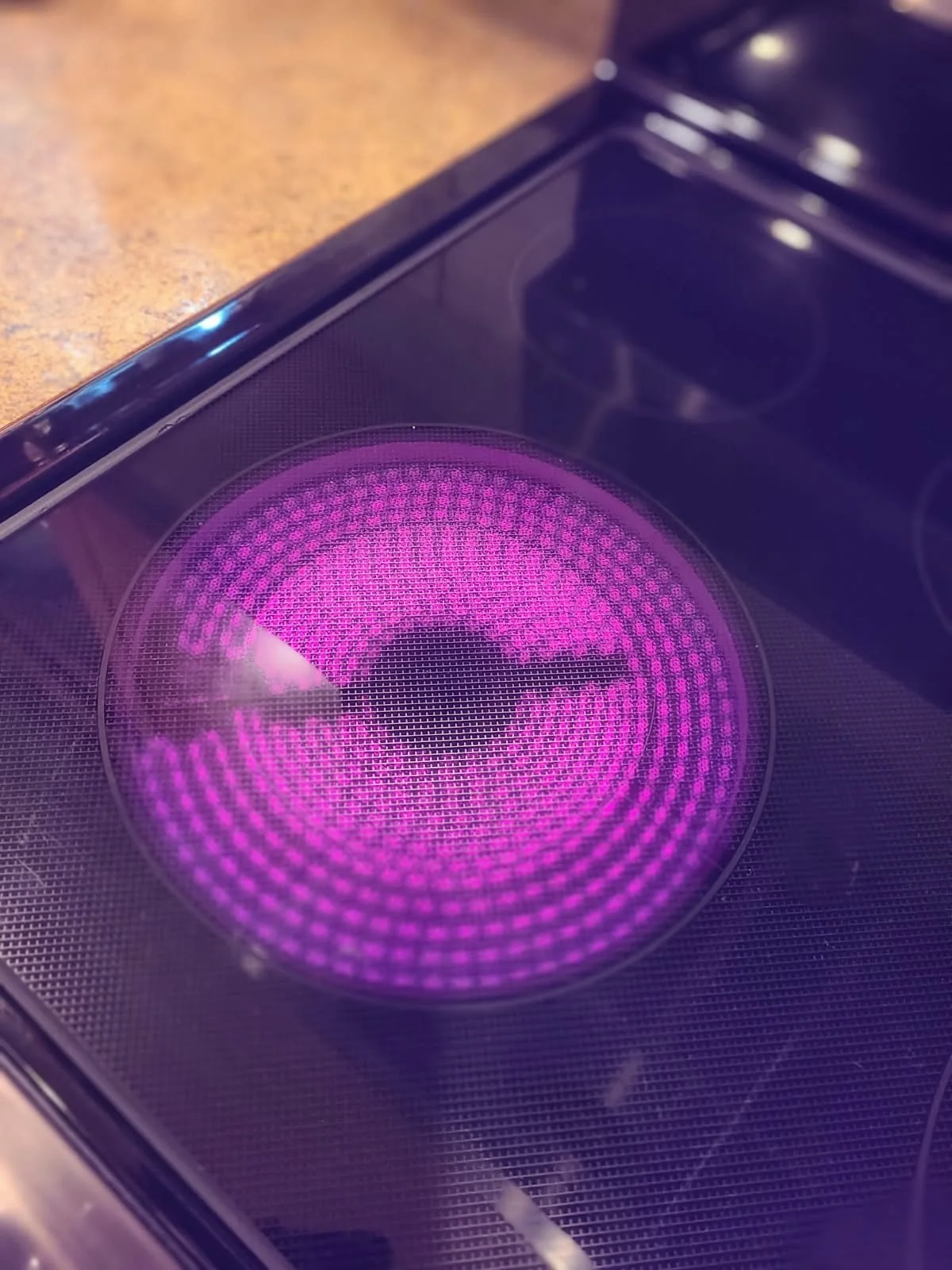 Radiant cooktop element glowing during an operating check on the LG range