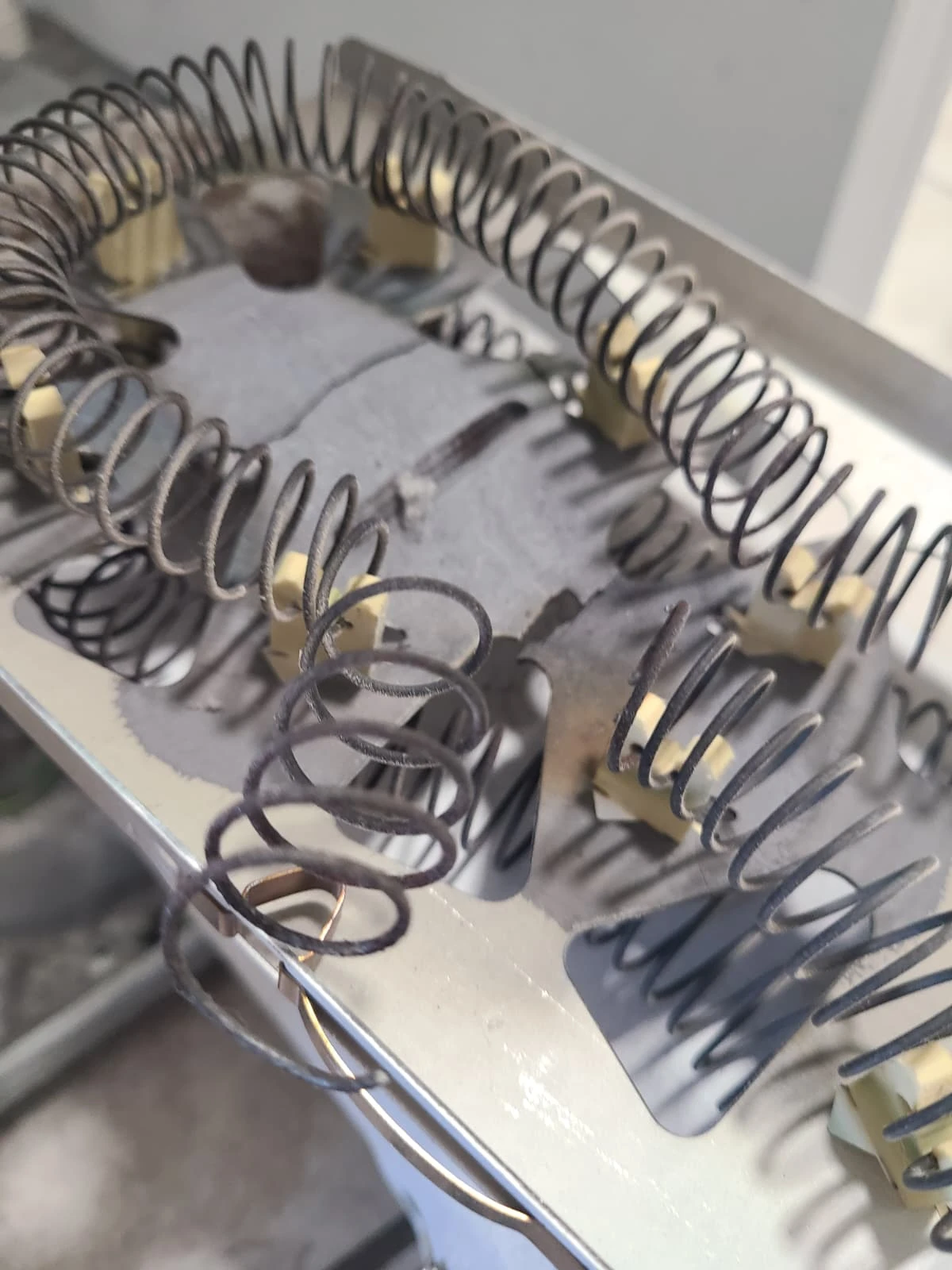 Break in the removed heating element coil from the Maytag dryer