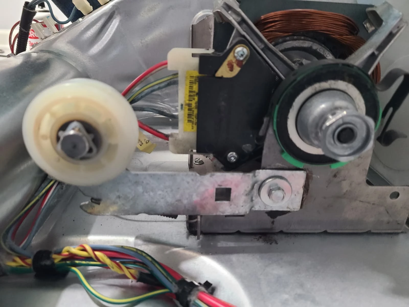 Replacement idler pulley installed beside the dryer drive motor