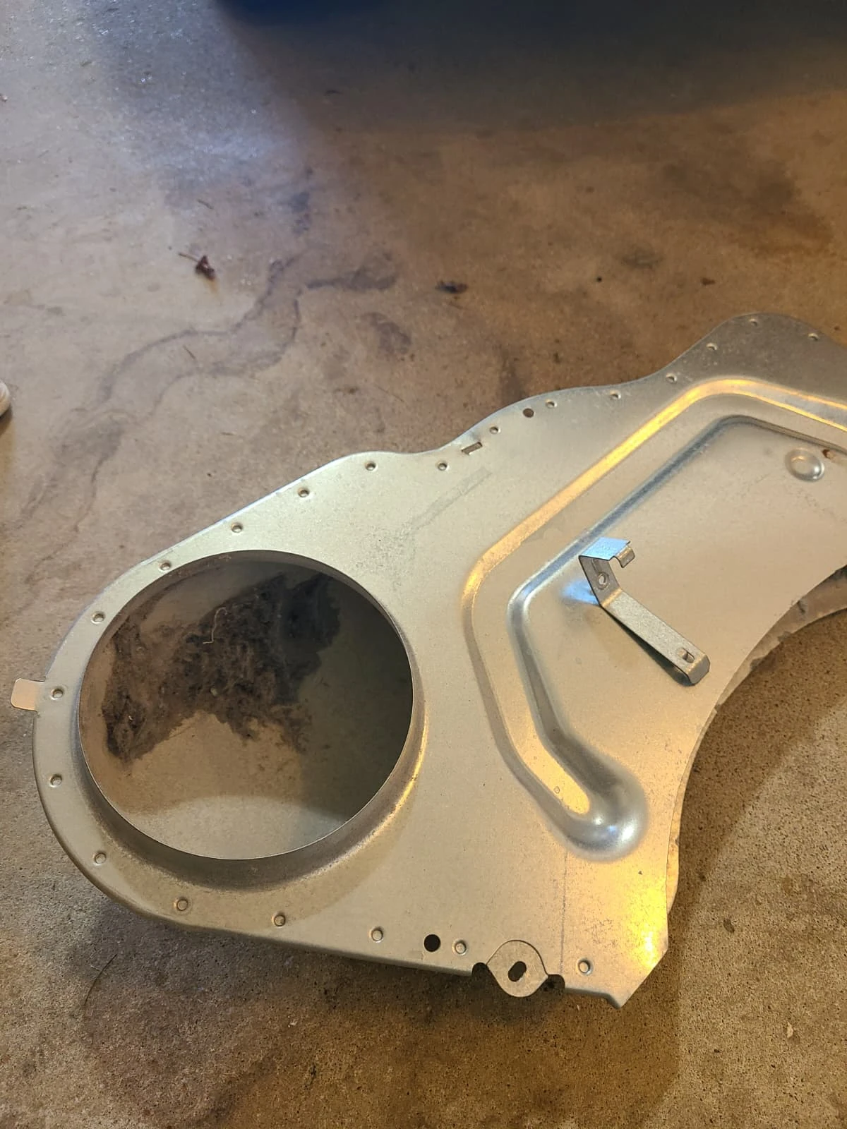 Lint inside the removed internal air duct during the dryer service