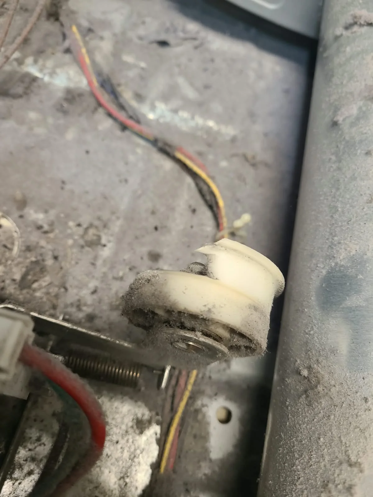 Damaged white idler pulley found during disassembly