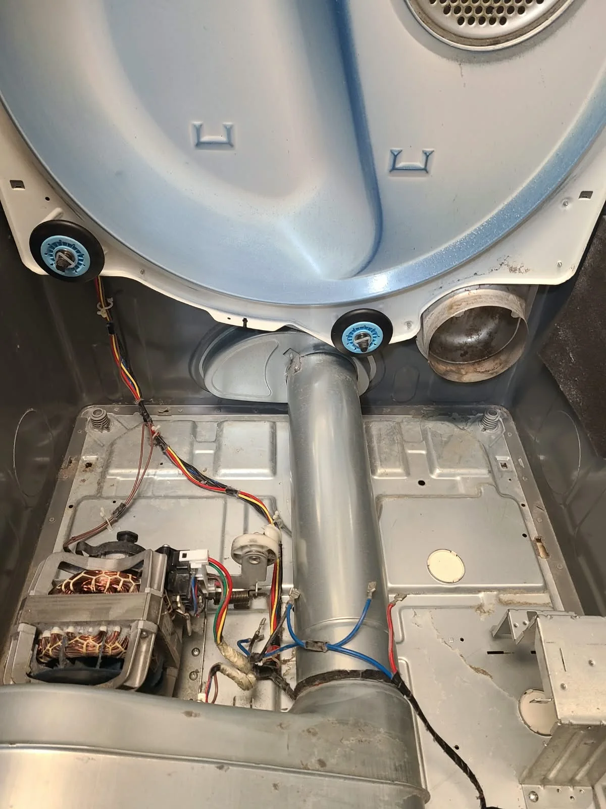 Cleaned dryer cabinet with replacement rear rollers and the heater removed during service