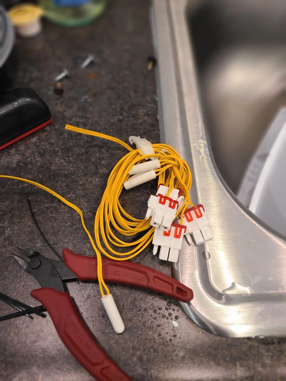 Temperature sensors on the work surface during service; one temperature sensor was replaced on this refrigerator